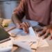 Girl sitting at the table with textbooks and studying